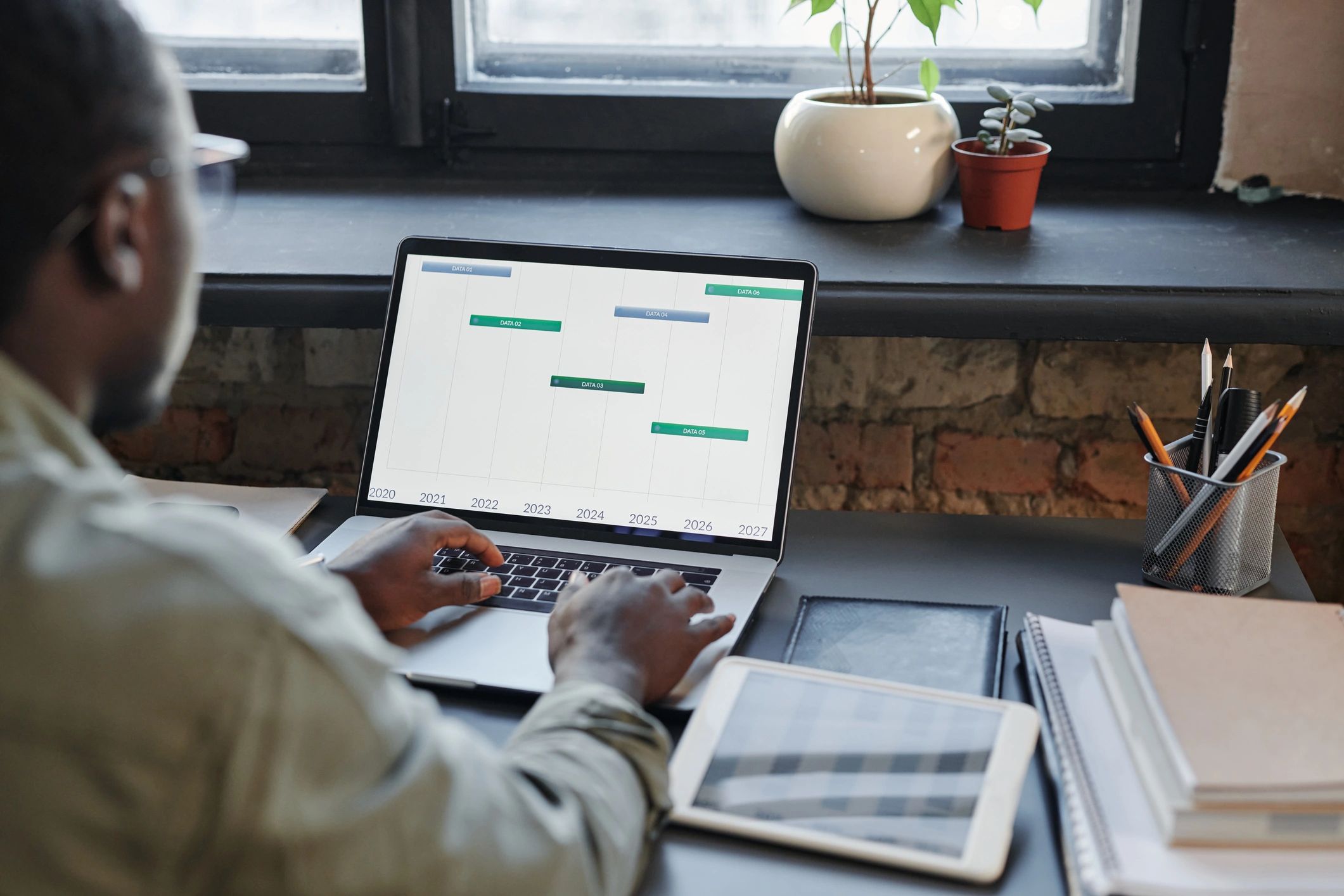 Software architect reviewing system design on a laptop in an office setting